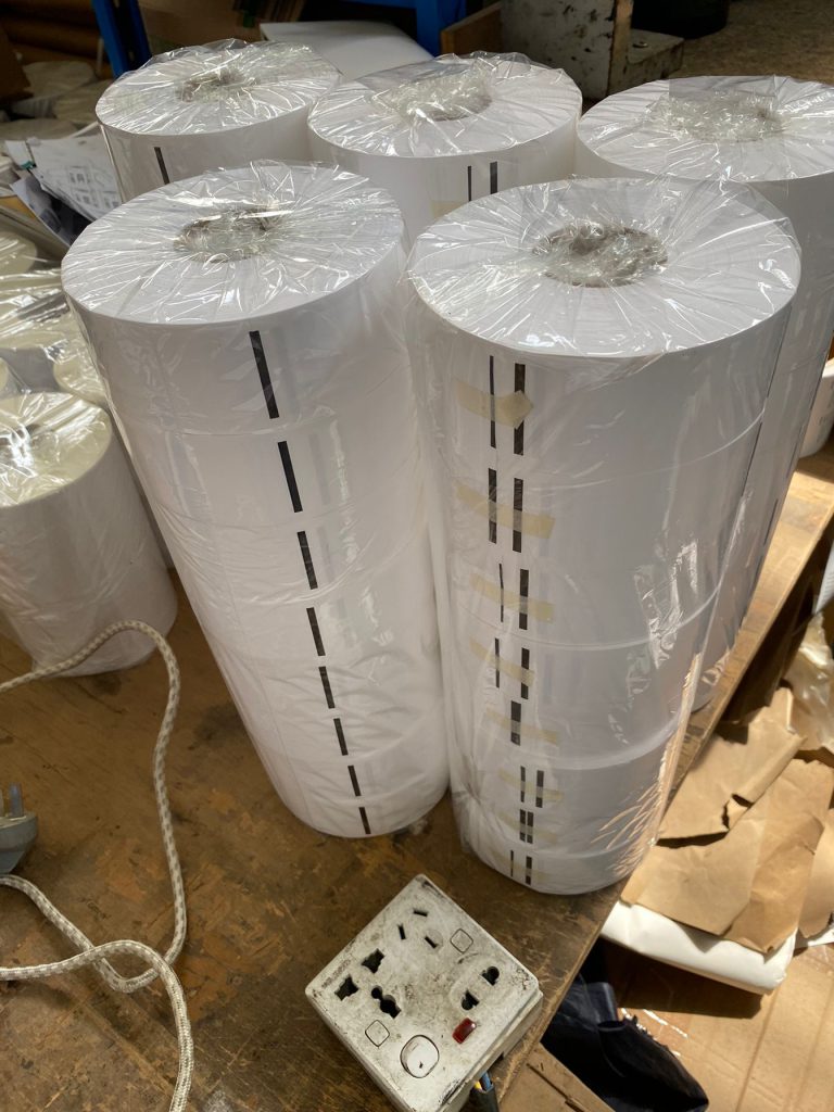 Punching position and register tracking marks on printable nylon wash label