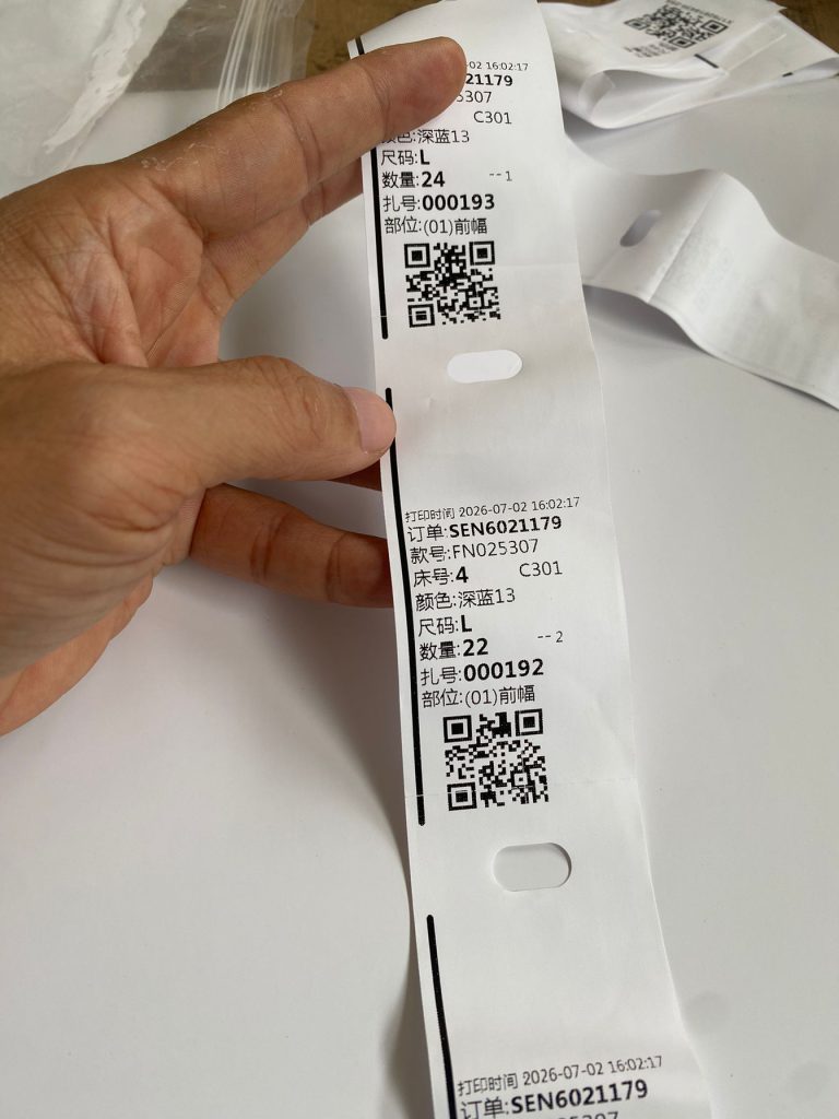 Punching position and register tracking marks on printable nylon wash label